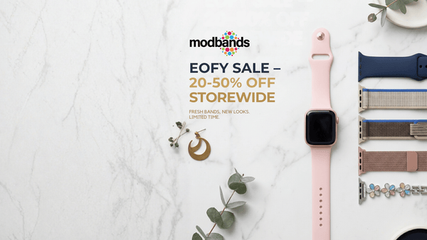Smartwatch with interchangeable bands on a marble surface, featuring Modbands EOFY sale text.